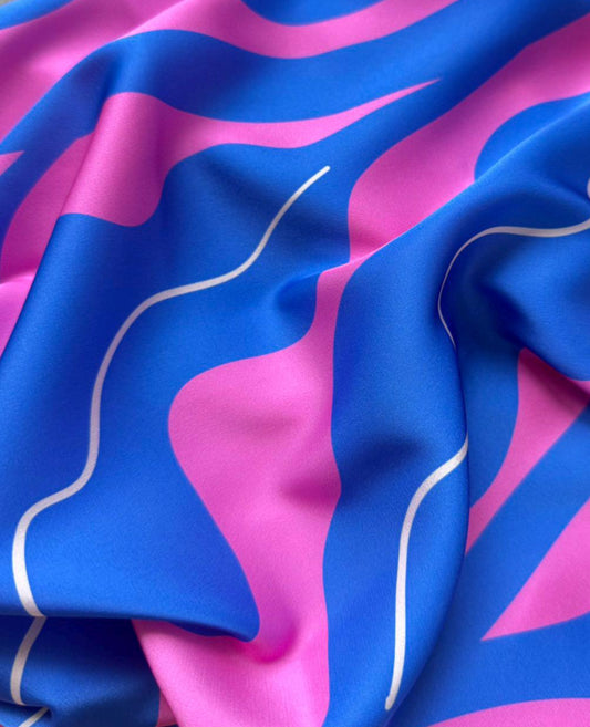 Blue and pink patterned fabric with white lines on a gray background